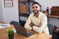 Young arab man business worker using laptop sitting on arms crossed gesture at office Royalty Free Stock Photo