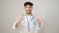 Young arab man doctor doing thumbs up over isolated white background