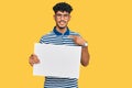 Young arab man holding blank empty banner pointing finger to one self smiling happy and proud Royalty Free Stock Photo