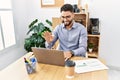 Young arab man smiling confident having video call working at office Royalty Free Stock Photo