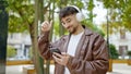 Young arab man smiling confident listening to music and dancing at park Royalty Free Stock Photo
