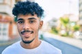 Young arab man smiling happy looking to the camera at street of city Royalty Free Stock Photo