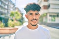 Young arab man smiling happy looking to the camera at street of city Royalty Free Stock Photo