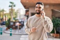 Young arab man talking on the smartphone and smoking at street Royalty Free Stock Photo