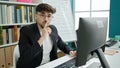 Young arab man using computer asking for silence at university classroom Royalty Free Stock Photo