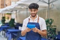 Young arab man waiter using touchpad working at restaurant Royalty Free Stock Photo