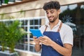Young arab man waiter using touchpad working at restaurant Royalty Free Stock Photo