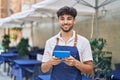 Young arab man waiter using touchpad working at restaurant Royalty Free Stock Photo