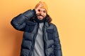 Young arab man wearing casual winter clothes smiling happy doing ok sign with hand on eye looking through fingers Royalty Free Stock Photo