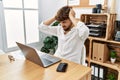 Young arab man working using computer laptop at the office suffering from headache desperate and stressed because pain and Royalty Free Stock Photo