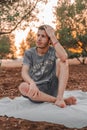 Young Arab model sitting on a white picnic blanket outdoors