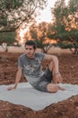 Young Arab model sitting on a white picnic blanket outdoors