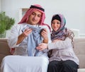 Young arab muslim family with pregnant wife expecting baby Royalty Free Stock Photo