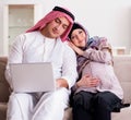 Young arab muslim family with pregnant wife expecting baby Royalty Free Stock Photo