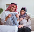 Young arab muslim family with pregnant wife expecting baby Royalty Free Stock Photo