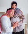 Young arab muslim family with pregnant wife expecting baby Royalty Free Stock Photo