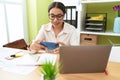 Young arab woman business worker using laptop and smartphone at office Royalty Free Stock Photo