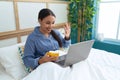 Young arab woman drinking coffee having video call at bedroom Royalty Free Stock Photo