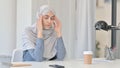 Young Arab Woman Feeling Worried while Thinking in Office