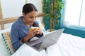 Young arab woman using laptop drinking coffee at bedroom Royalty Free Stock Photo