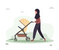 Young arab woman walking with her newborn child in an pram. Girl on a walk with a stroller and a baby in nature in the Royalty Free Stock Photo