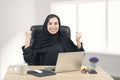 Young Arabian businesswoman expressing success at office