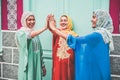 Young arabian girls stacking hands outdoor - Islamic happy women celebrating together - Youth lifestyle, university, relationship