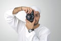 Young Arabian man using holding his camera ready to shoot, isolated Royalty Free Stock Photo