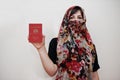 Young arabian muslim woman in hijab clothes hold Republic of the Union of Myanmar passport on white wall background, studio