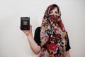 Young arabian muslim woman in hijab clothes hold Syrian Arab Republic passport on white wall background, studio portrait Royalty Free Stock Photo