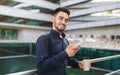 Young Arabic businessman using his phone gadget in urban area Royalty Free Stock Photo