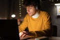 Young arabic ethnic businessman or student remote working overtime, learning online late at night at home or in dark Royalty Free Stock Photo