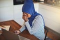 Young Arabic female entrepreneur sitting at home looking stresse