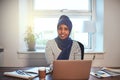 Young Arabic female entrepreneur smiling while working from home Royalty Free Stock Photo