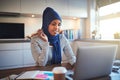 Young Arabic entrepreneur working on a laptop in her kitchen Royalty Free Stock Photo