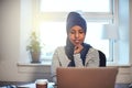 Young Arabic female entrepreneur working at home on a laptop Royalty Free Stock Photo