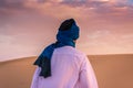 Young arabic man wearing traditional berber clothes in the Sahara Desert of Merzouga, Morocco