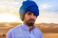 Young arabic man wearing traditional berber clothes in the Sahara Desert of Merzouga, Morocco Royalty Free Stock Photo
