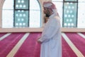 Young Arabic Muslim man  praying. Religious muslim doing a pray inside the mosque Royalty Free Stock Photo