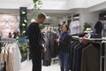 Man checking jacket in clothing store