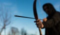 Young archer holding hes traditional hungarian bow, shallow depth of field, space for text