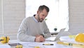 Young Architect Engineer Writing at Work in Office Royalty Free Stock Photo