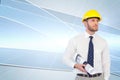 Young architect posing with hard hat and plan