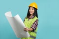 Young architect woman engineer designer employee white woman 30s she wear hardhat hold look at drawing blueprints isolated on Royalty Free Stock Photo