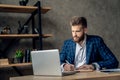 Young architect work project. Photo of bearded man working with new startup project in modern loft office. Generic design notebook Royalty Free Stock Photo