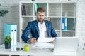 Young architect work project. Photo of bearded man working with new startup project in modern loft office. Generic design notebook Royalty Free Stock Photo