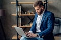 Young architect work project. Photo of bearded man working with new startup project in modern loft office. Generic design notebook Royalty Free Stock Photo