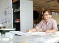 Young architect working on drawing table in architect studio. Royalty Free Stock Photo