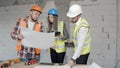 Young architects check new blueprints for a building