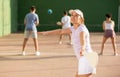 Young Argentinian woman playing pelota at open-air fronton in summer